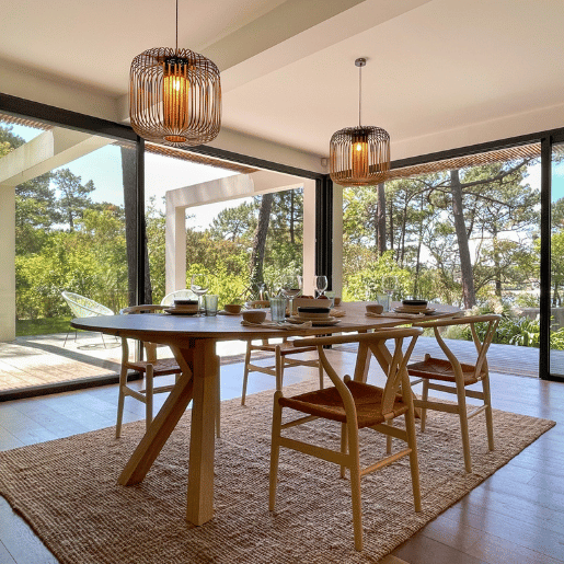 Salle à manger avec de belles baies vitrées avec vue sur la fôret de pin