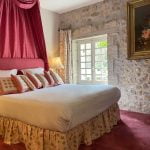 chambre lit double avec fenêtre blanche et moquette rose